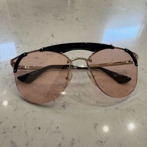 Pink rimless Prada sunglasses